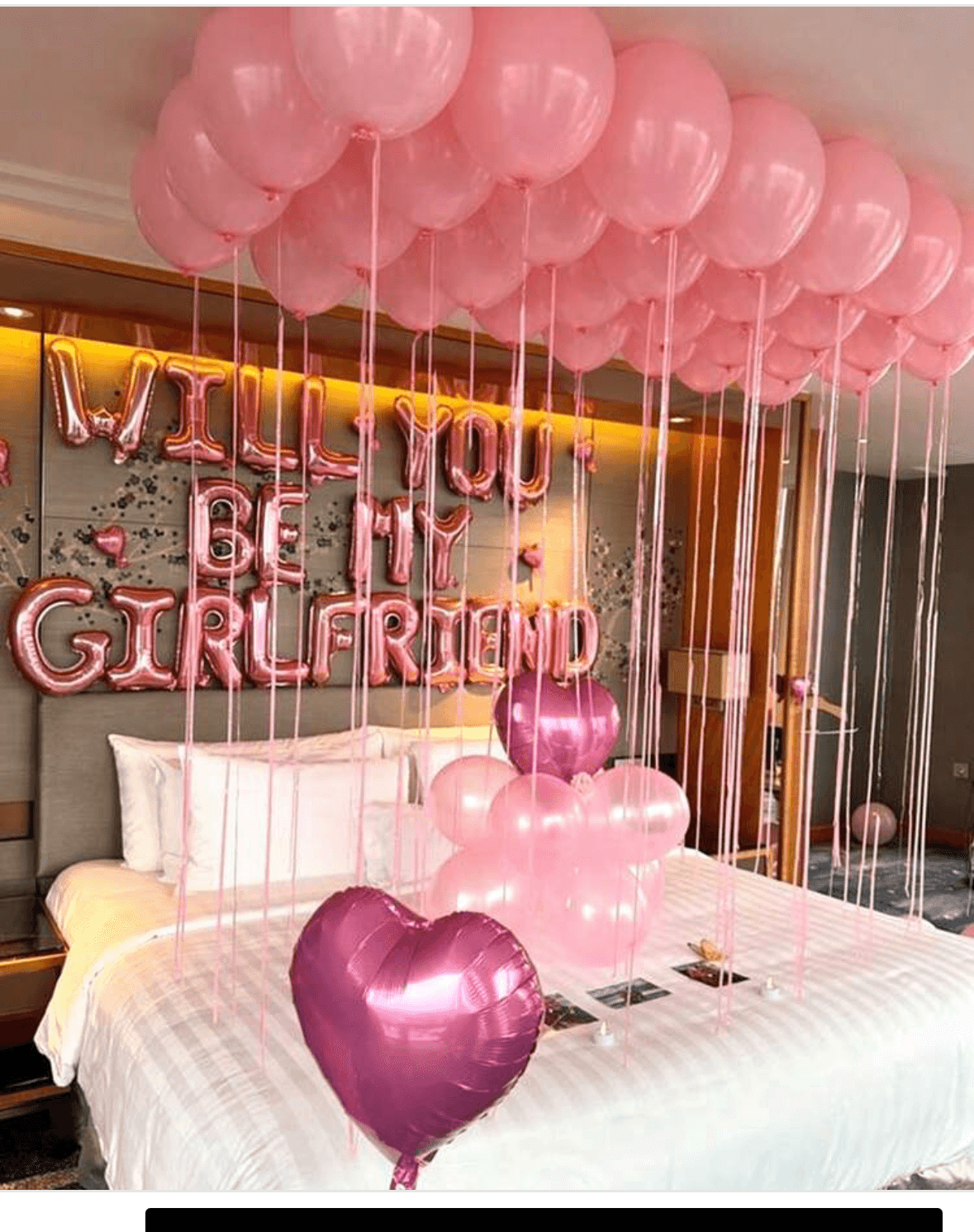 Romantic proposal setup with pink balloons